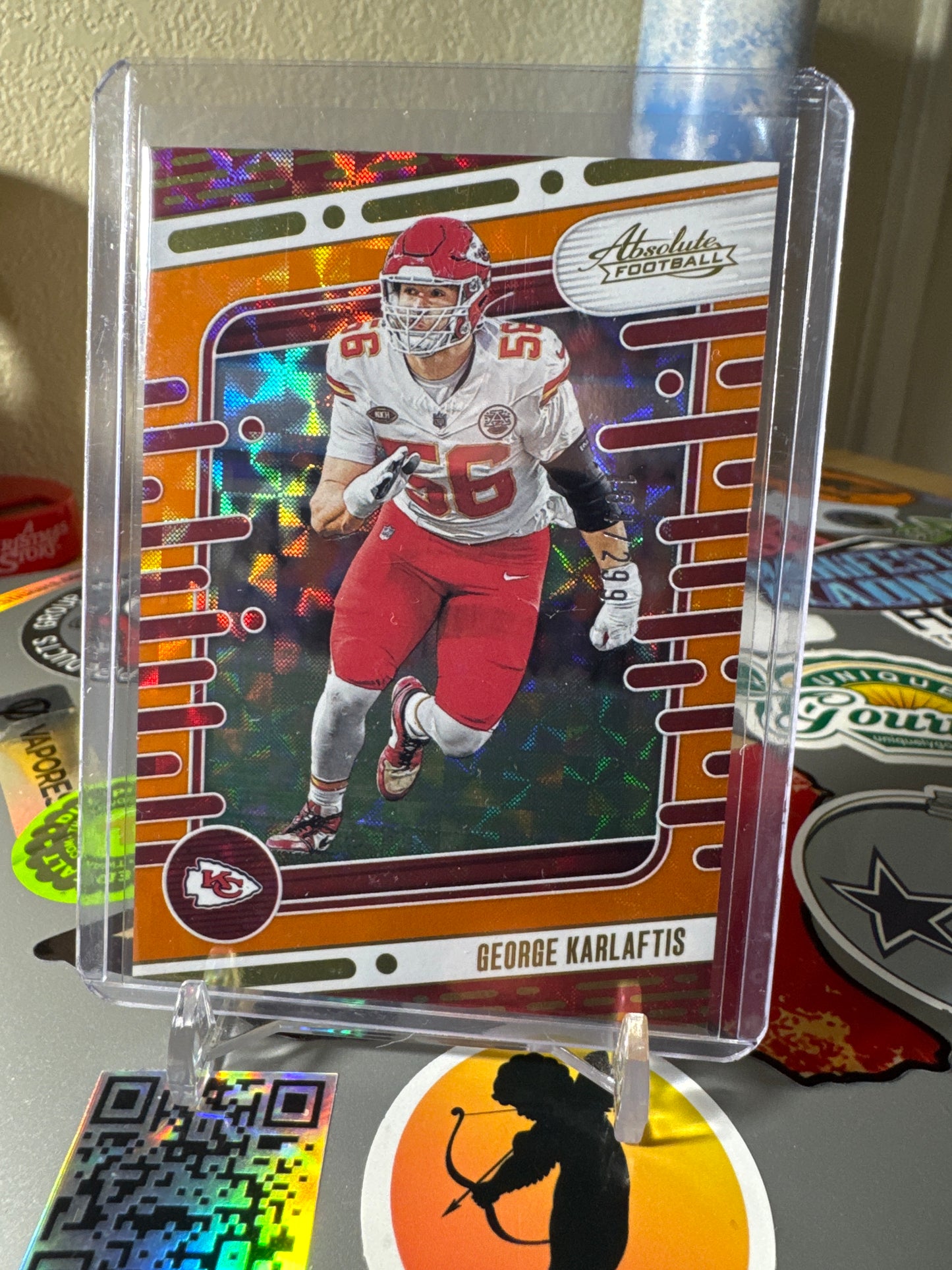 2024 Panini Absolute #53 George Karlaftis- Orange Mosaic Foil Parallel. Numbered 184/299
